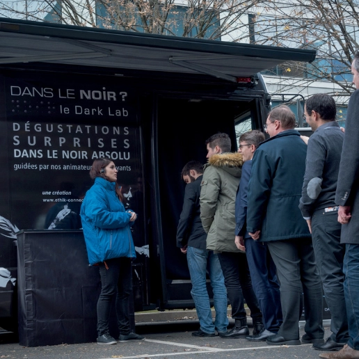 Person preparing to enter the Dans le Noir ? mobilab for a unique experience