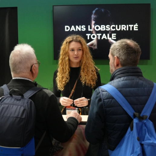 Dans le Noir ? project manager  explaining the black box experience to visitors at the International Agricultural Show