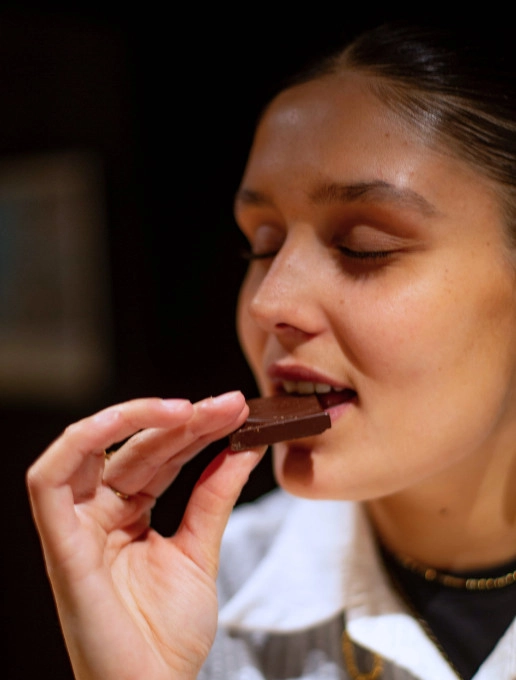 Person tasting a piece of chocolate
