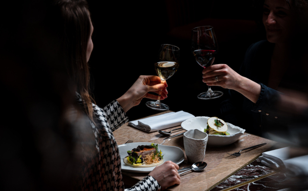 People toasting during a unique dining experience in the dark